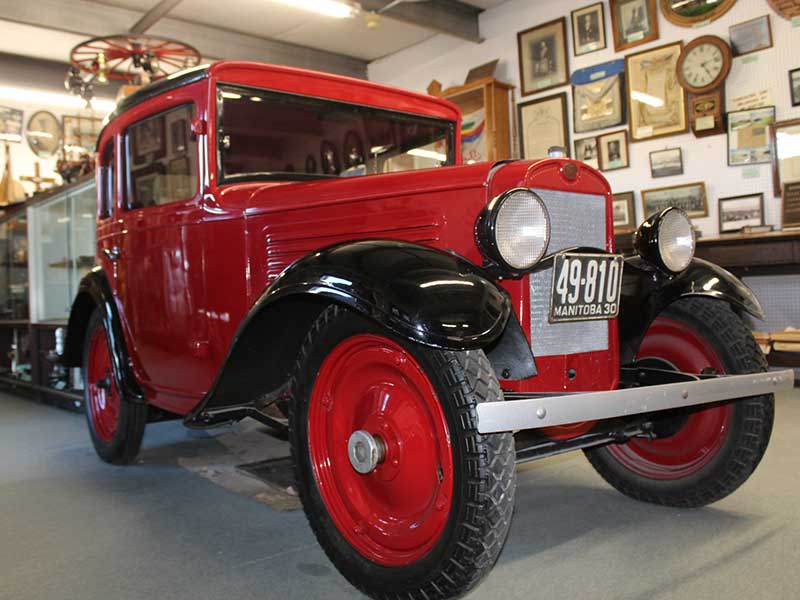 A red, antique car on display at the Manitoba Antique Automobile Museum in Elkhorn, Manitoba