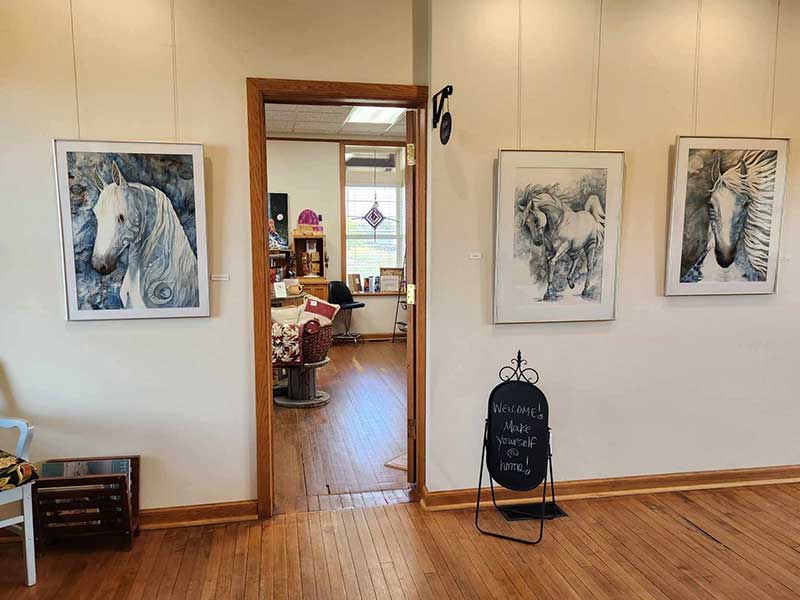 A display of artwork on the walls of the Arts Mosaic in the Historic CPR Centre, Virden, Manitoba